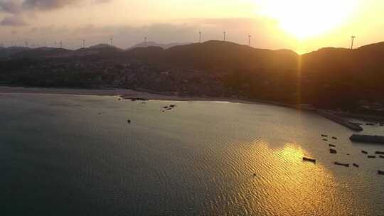 航拍平潭岛渔村夕阳与海岛风力发电风电风机