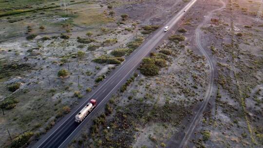 航拍行驶在笔直公路上的货车