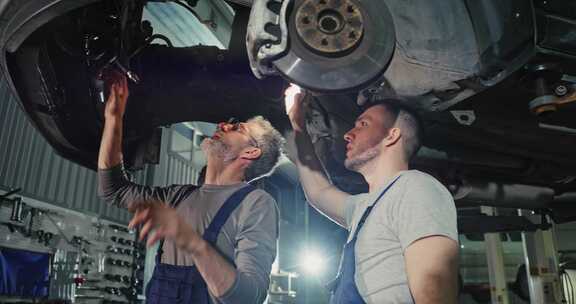 在汽车服务中心，穿着制服的英俊年轻汽车机