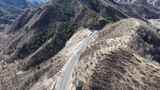 航拍山间蜿蜒公路高清在线视频素材下载