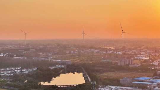 航拍平原夕阳落日房屋风力发电晚霞鸟类