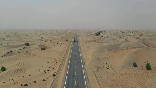 航拍沙漠公路行驶的货车荒漠戈壁笔直的公路