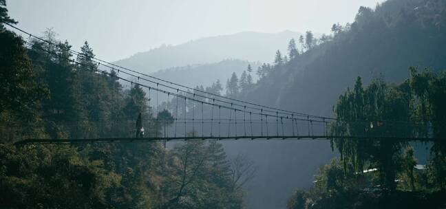 游客走在山林中的桥上