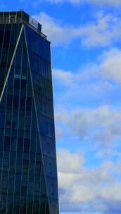 蓝天下玻璃建筑上的云景反射