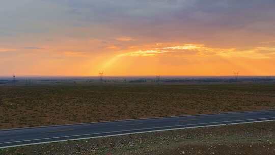 航拍夕阳下的戈壁公路