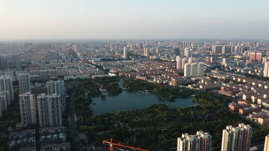 航拍山东济宁城市南池公园城市落日