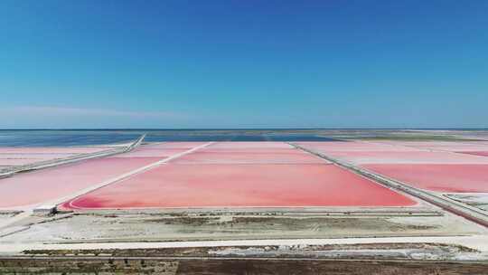 在粉色沉积物的阿尔巴尼亚海盐农场上空飞行视频素材模板下载