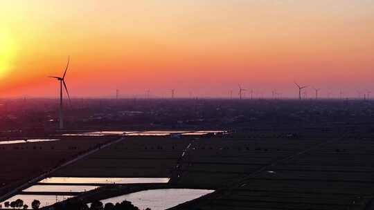 航拍田野农村民房别墅风力发电夕阳池塘