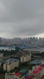 竖版航拍城市暴雨来临高楼雨季