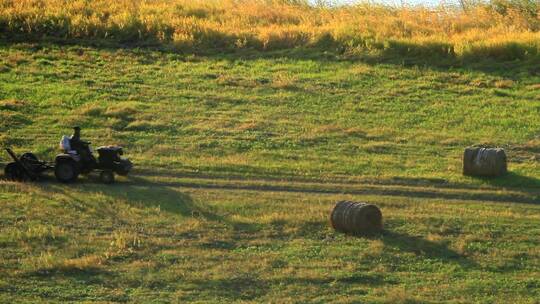额尔古纳乡村农民驾驶拖拉机收割牧草