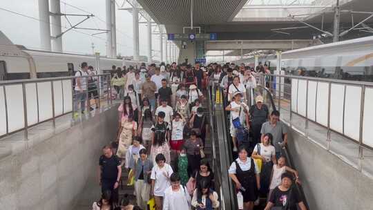 高铁列车站台旅客行李箱阶梯下行出站的旅客