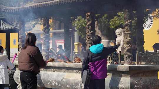 人们在寺庙中烧香祈福的场景