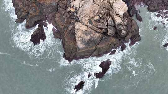 海岸礁石海水拍打礁石阴天海滩岩石海浪冲刷