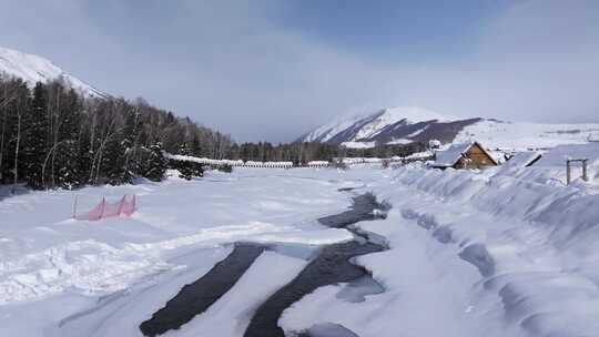 航拍新疆禾木雪景森林雪地小木屋禾木桥雪山