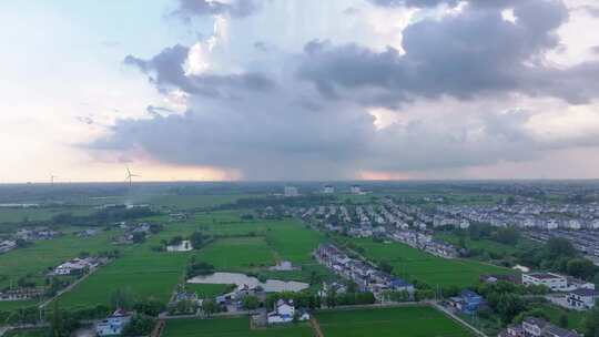 航拍平原地区局部下雨暴雨雨幕夕阳乌云