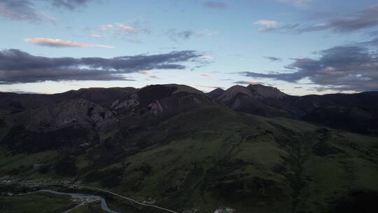 航拍格聂神山草原落日夕阳晚霞