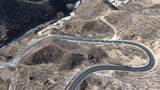 航拍山间蜿蜒公路高清在线视频素材下载