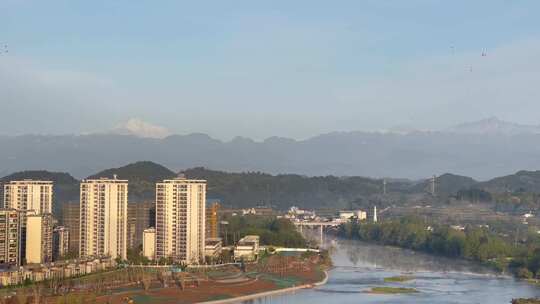 雪山山林城镇建筑楼房河流油菜花1