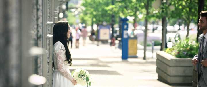 新娘和新郎一起站在人行道上，互相微笑