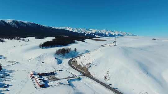 雪山下雪地建筑与公路航拍