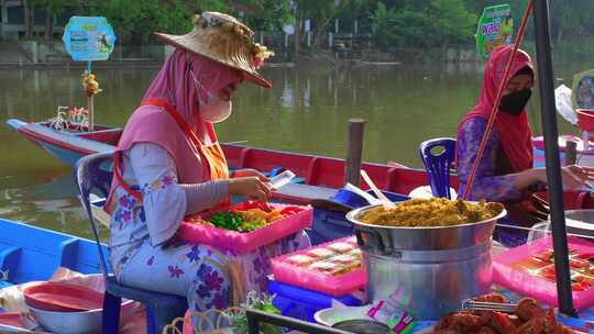 河边卖街头食品的女小贩