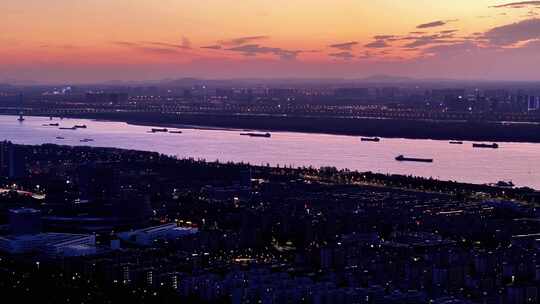 航拍长江落日夕阳南京江心洲轮船航运夜景