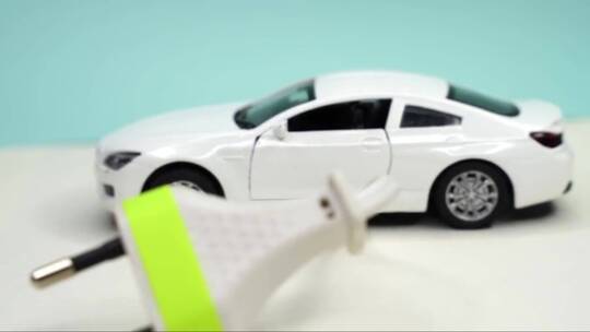 玩具车和电插头。电动汽车和绿色汽车概念视频素材模板下载