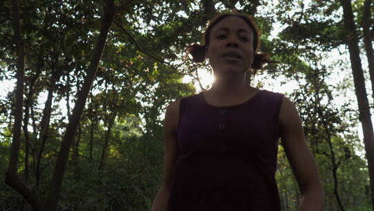 黑人女青年惊悚奔跑在落日森林