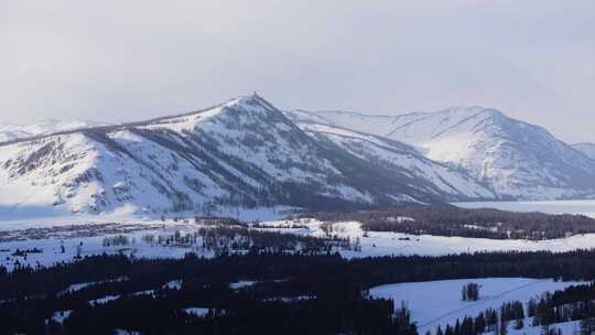 航拍新疆冬季喀纳斯湖雪景雪山森林冰河晨雾