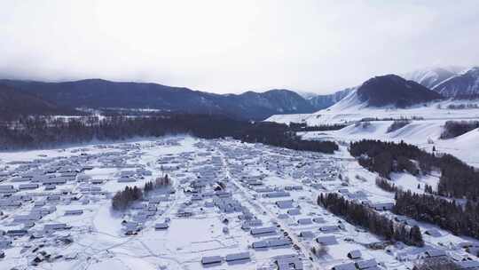 航拍新疆禾木雪景森林雪地小木屋禾木桥雪山