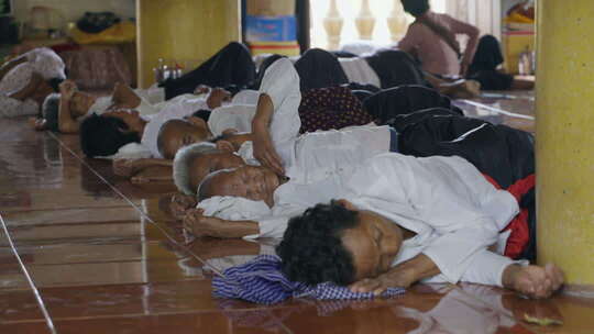 柬埔寨农村寺庙里在地上睡觉的老人