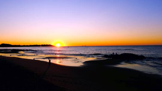 海滩上看日出的人与清晨海景唯美风光