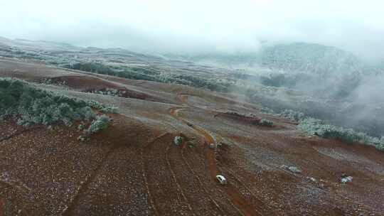 汽车行驶在大雪公路雪山无人机航拍