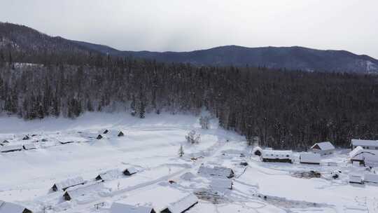 航拍新疆禾木雪景森林雪地小木屋禾木桥雪山