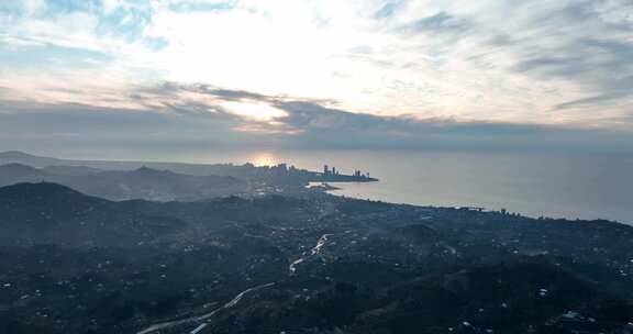 日出时海岸城市的鸟瞰图