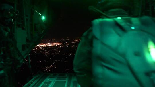 伞兵在夜视中从飞机上跳下来