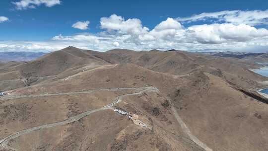 航拍西藏青藏高原蓝天白云下的高山景观