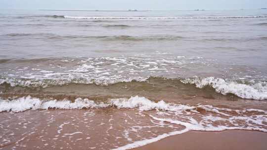 海水拍打在沙滩上