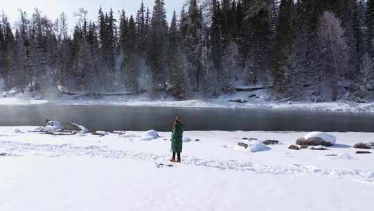 航拍新疆阿勒泰冬季喀纳斯游客在雪地上游玩