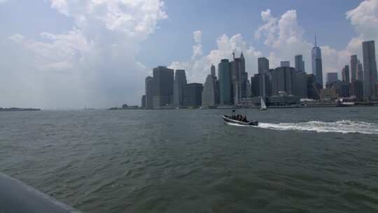 曼哈顿的城市景观，白天有船只穿越。