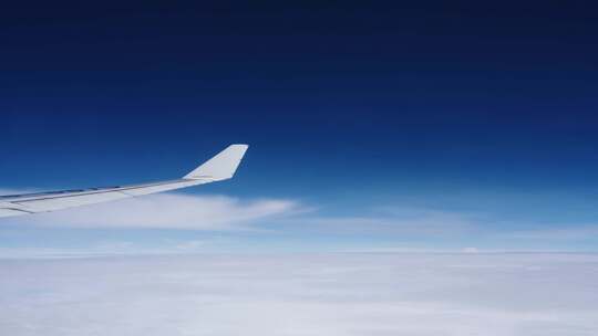 飞机上看窗外机翼划过蓝天白云视频素材模板下载