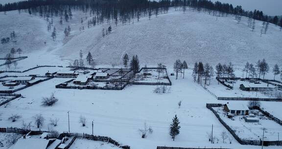 航拍东北林区冬季日暮雪村