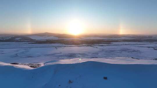 航拍寒冬雪域雪原灿烂夕阳