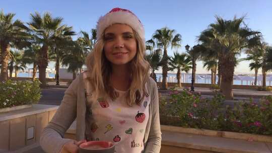 棕榈与海咖啡馆戴着圣诞帽的年轻漂亮女人的肖像