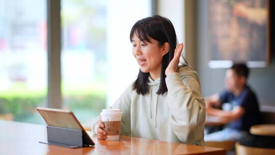 年轻女子在咖啡店使用平板电脑上网视频素材模板下载