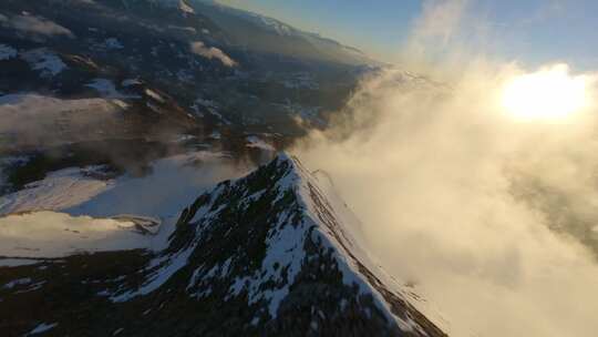 FPV穿越机无人机航拍雪山山顶日出山脉森林