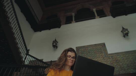 女人坐在台阶上玩电脑