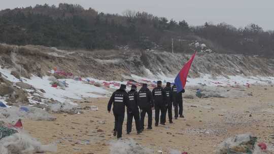 航拍山东威海海岸警察高举警旗巡逻踏查海岸
