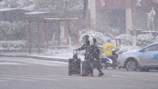 下雪天情侣拖着行李箱回家过年