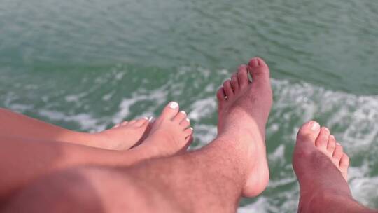 夫妇的脚在海上航行的船上